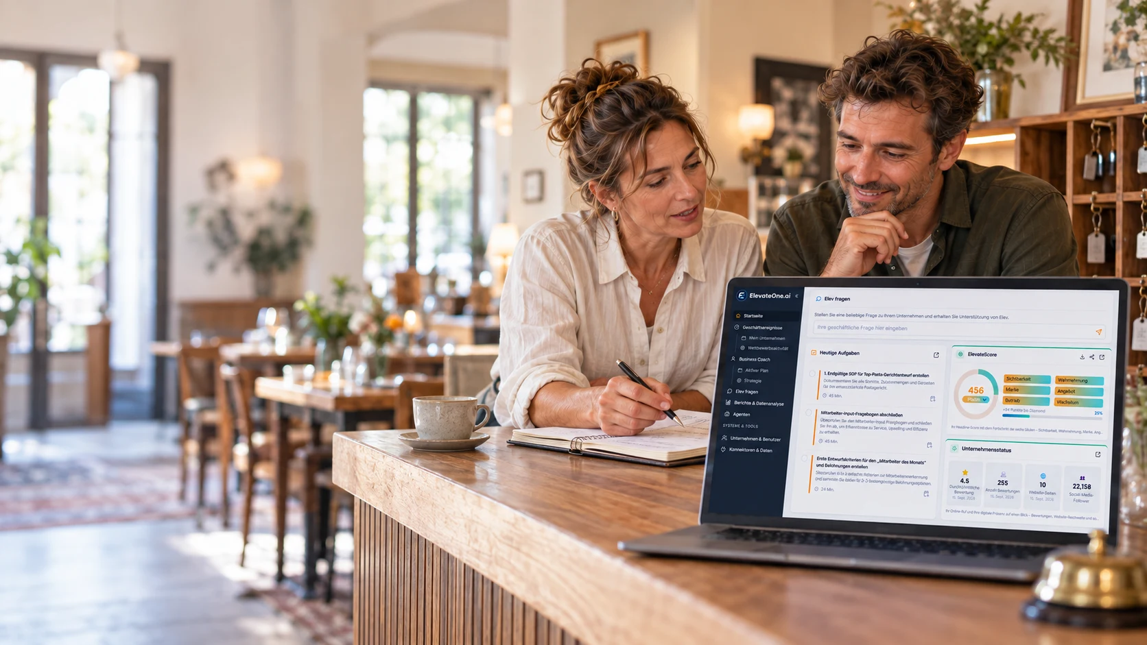 Two operators plan their next step together in a hotel and restaurant business, supported by ElevateOne on their laptop